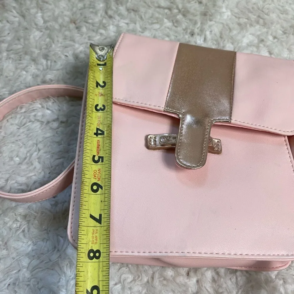 Juicy Couture pink and gold synthetic leather crossbody bag.
